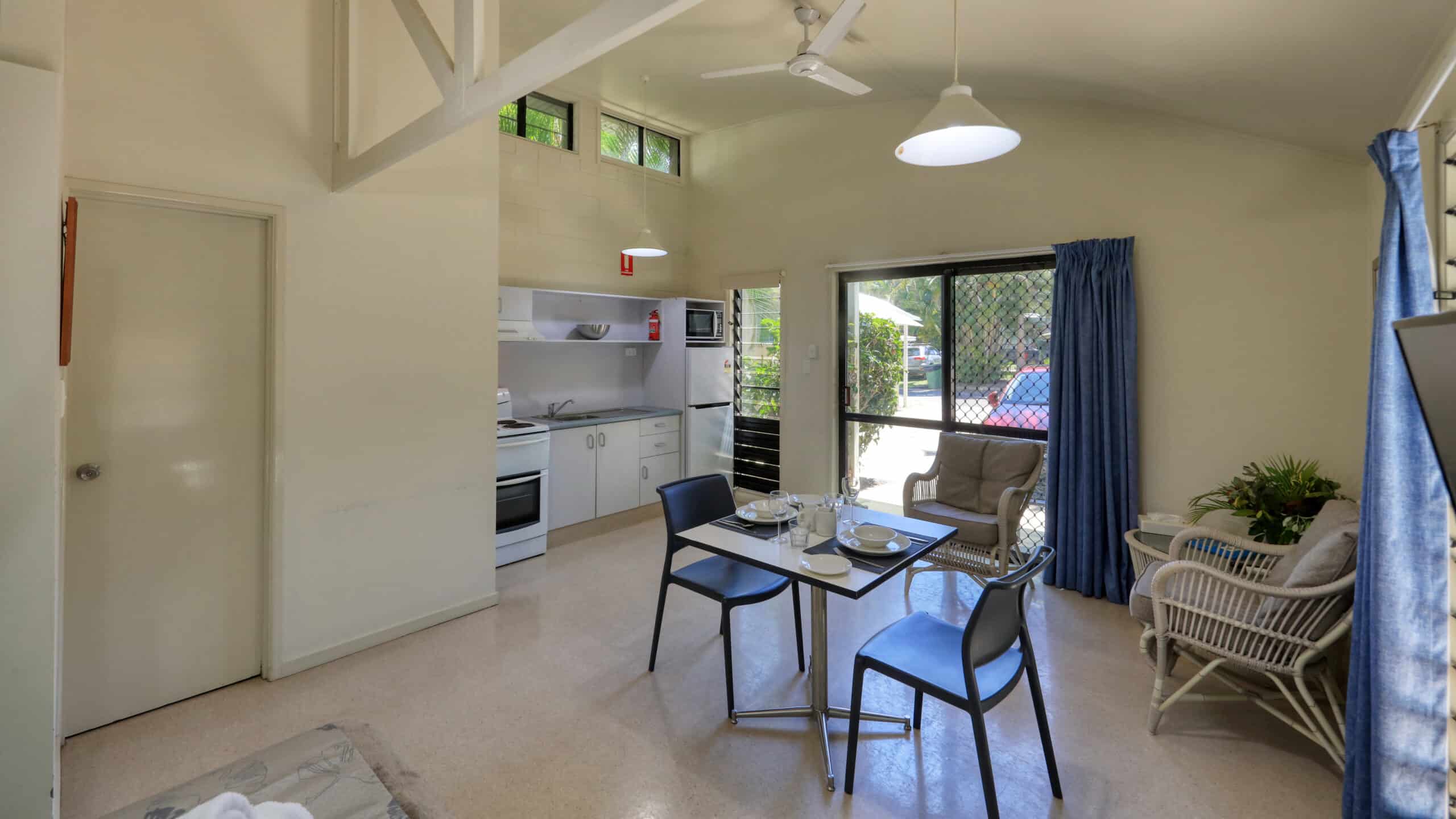 The dining and kitchen area in a Rainbow Beach Holiday Village Studio Villa