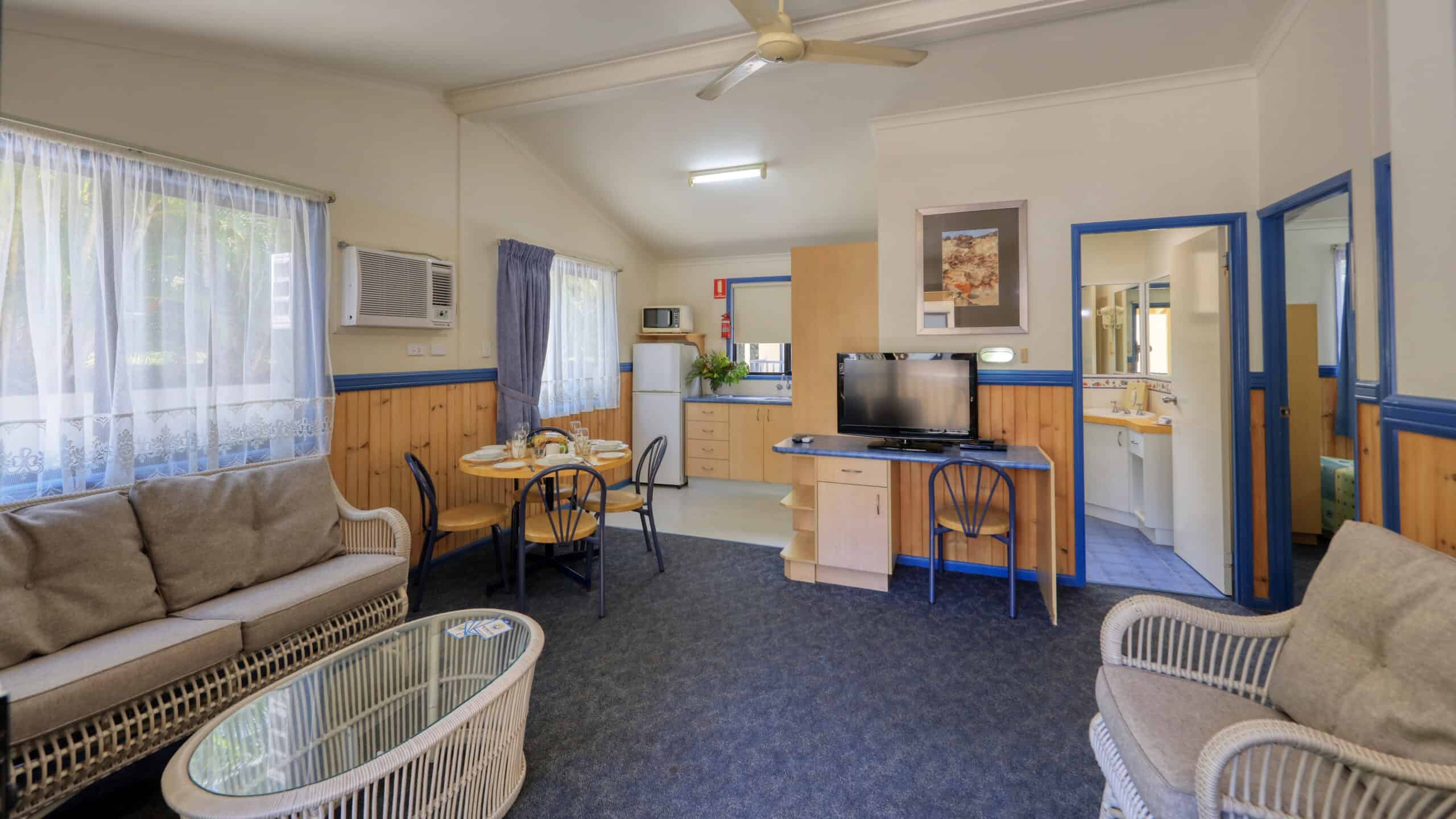 The living and dining area in a Chalet at Rainbow Beach Holiday Village