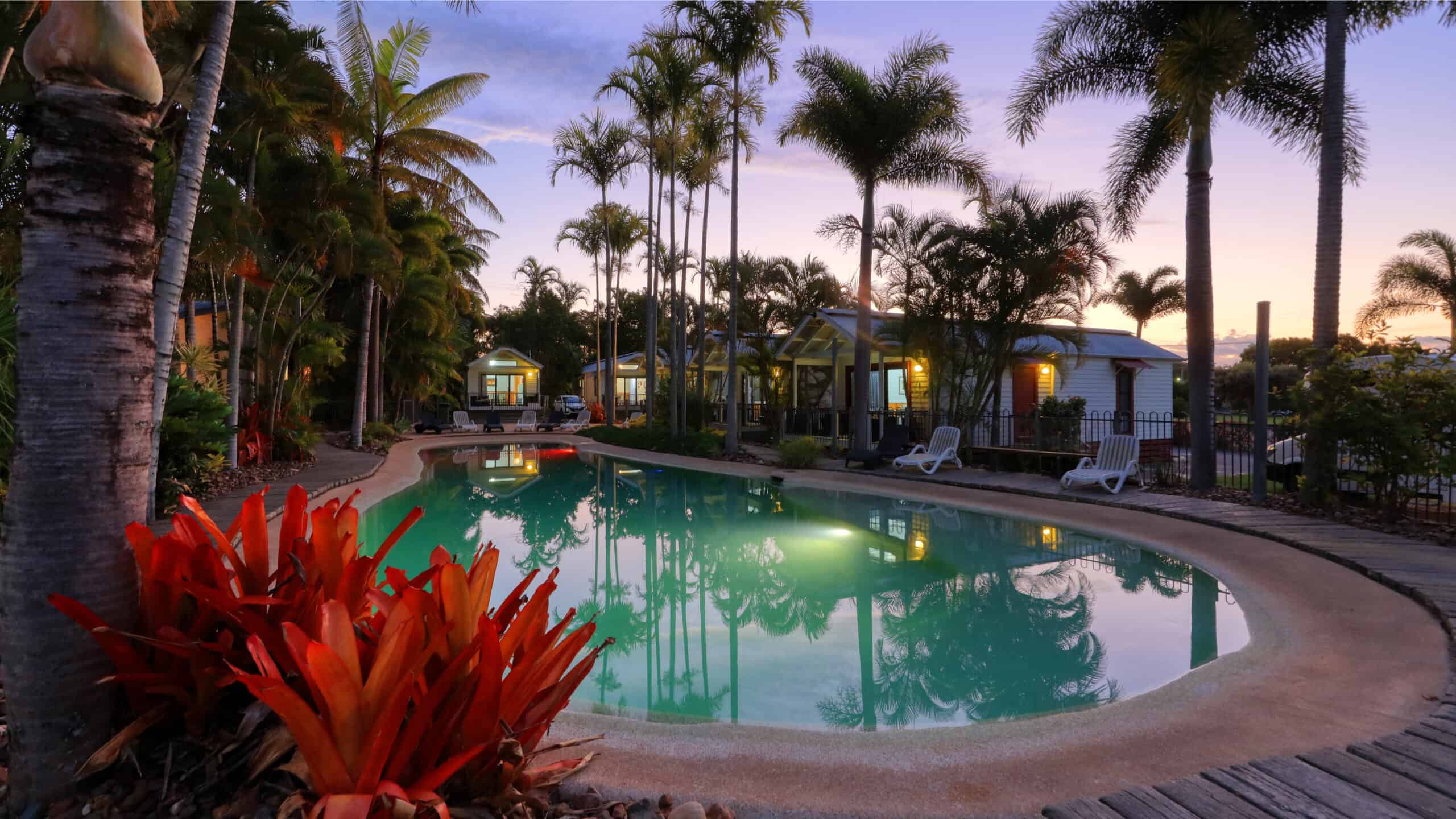 A beautiful pool area for relaxing at Rainbow Beach Holiday Village pictured at dusk