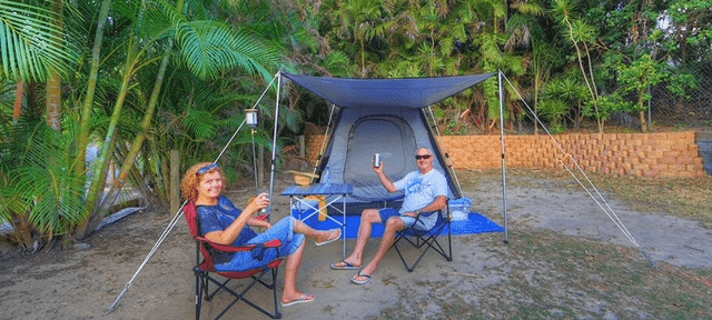 Two people enjoying themselves in their Tent Site accommodation at Rainbow Beach Holiday Village