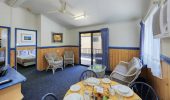 The living and dining area in a Chalet at Rainbow Beach Holiday Village