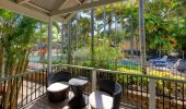 A verandah overlooking the pool from a Poolside Spa Villa at Rainbow Beach Holiday Village