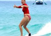 Girl surfing on the ocean
