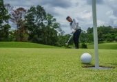 Golfer hitting a ball at the tee